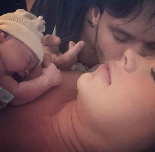 Indra Petersons with herdaughter after delivering her. baby, daughter, kid